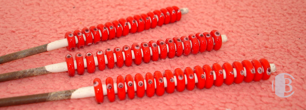 10mm x 3mm solid red with eye dots design lampwork spacer bead